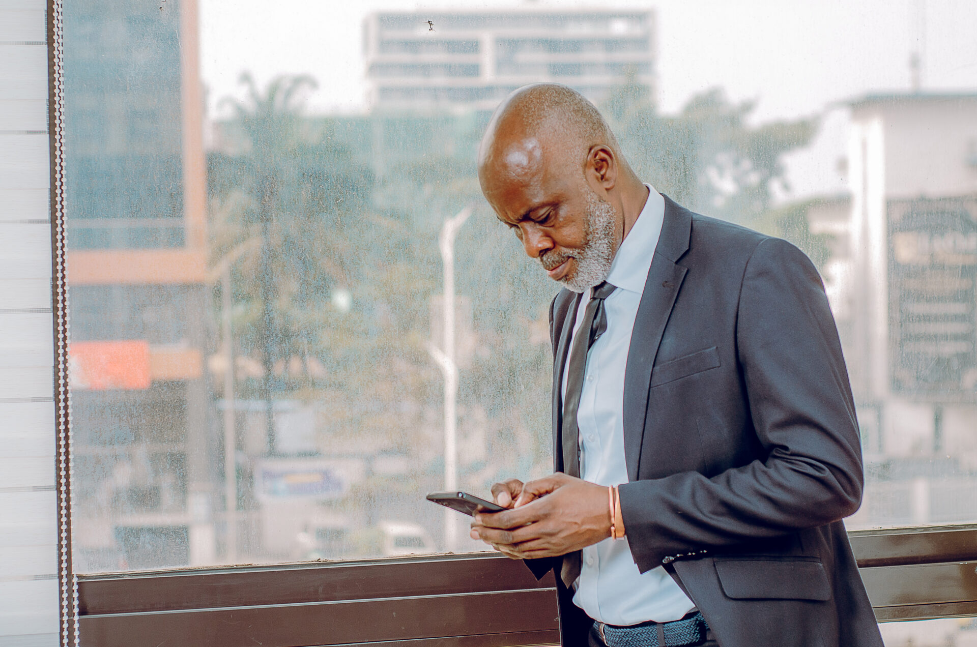 un-homme-noir-professionnel-qui-ecrit-sur-son-telephone-portable